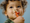 A child with a LEGO DUPLO animal in their mouth