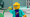 LEGO minifigure looking at a LEGO plant